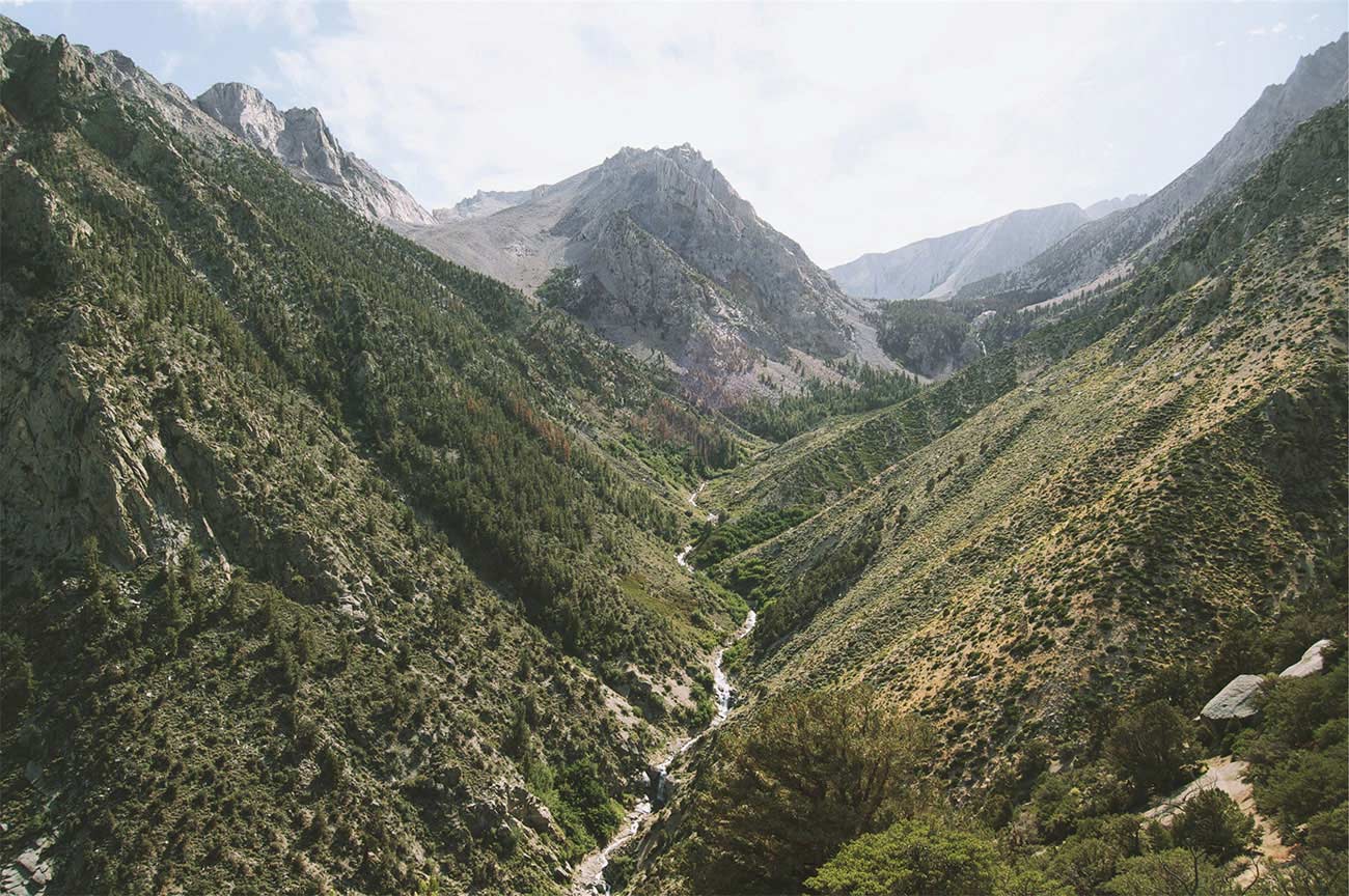 small stream running between two mountains